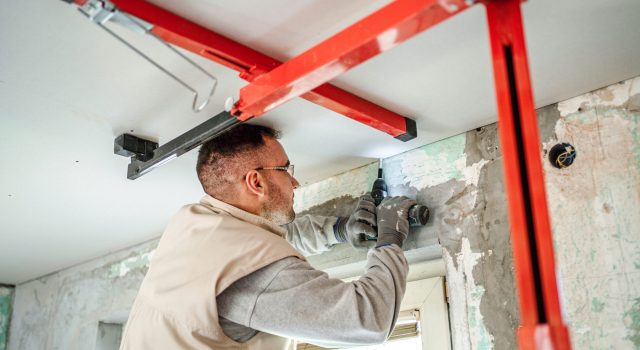 Man installing the roof in a property.