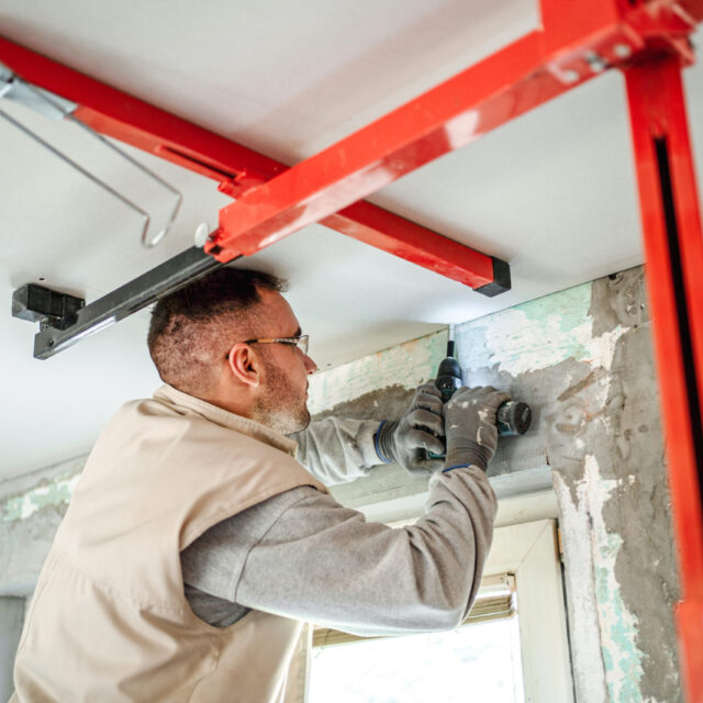 Man installing the roof in a property.