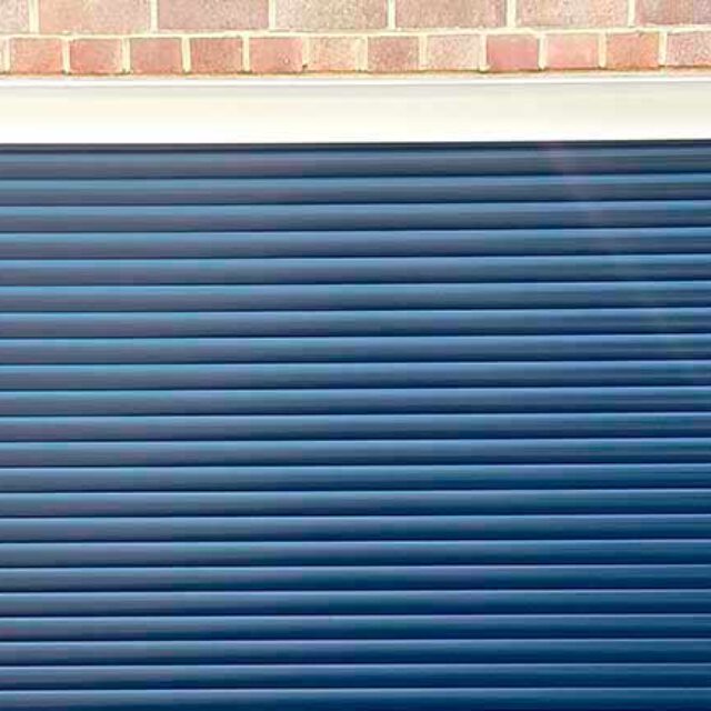 Close up of a blue roller garage door.