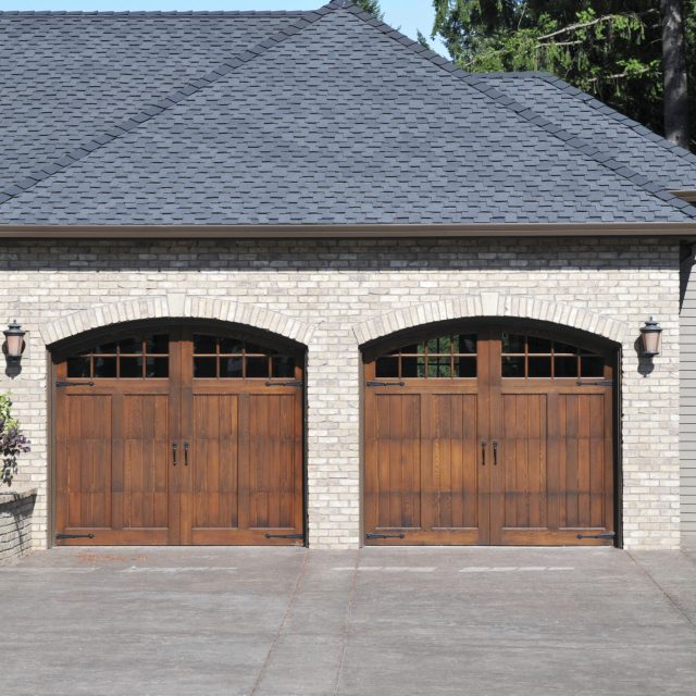 Double wooden side hinged garage doors.