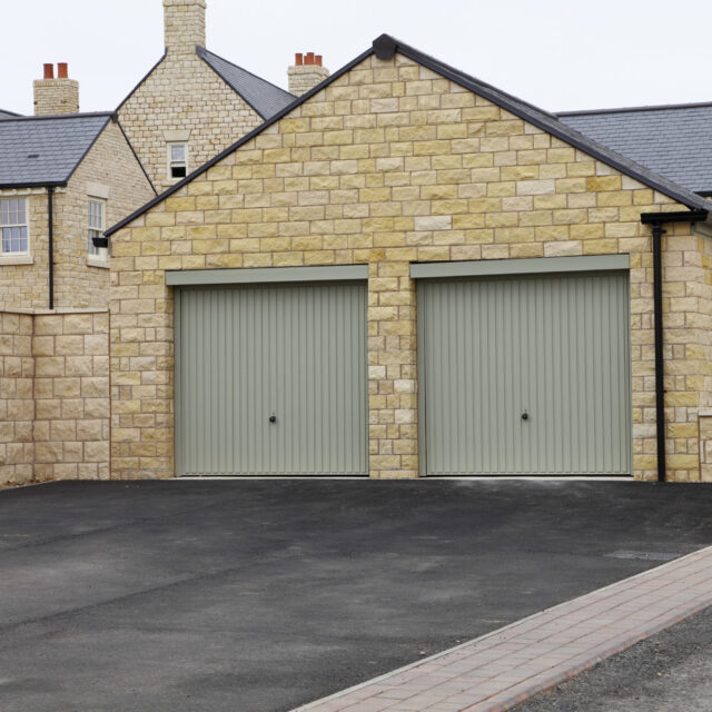 House with double grey garage doors.