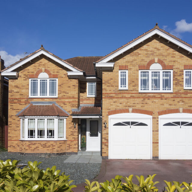 House with double white garage doors.