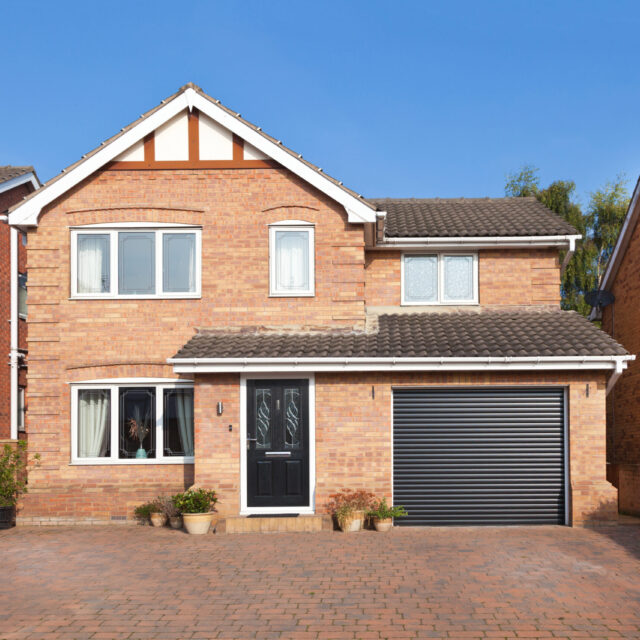 House with black garage door.